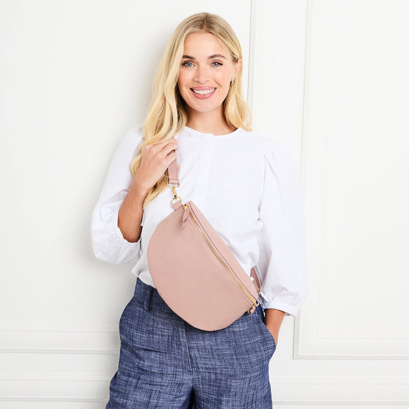 Model Image of a Large Blush Pink Leather Slingbag for Women by Elie Beaumont