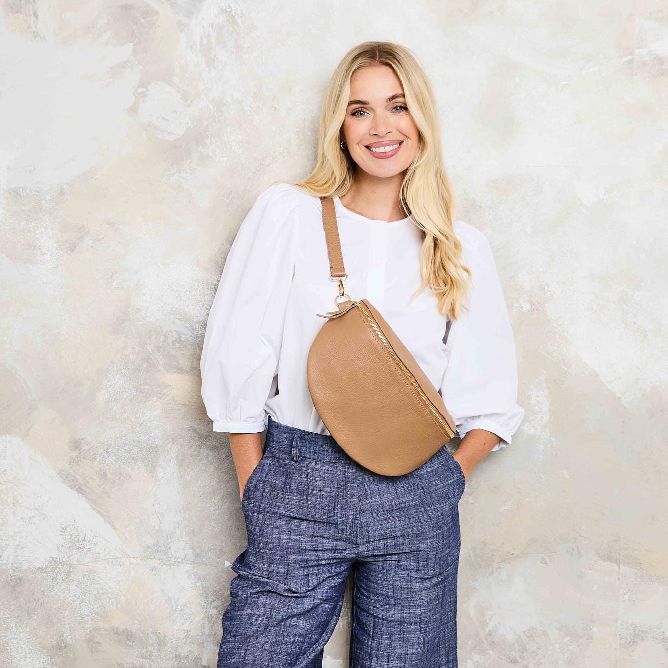 Model Image of a Camel Brown Leather Large Sized Slingbag with matching strap for Women by Elie Beaumont