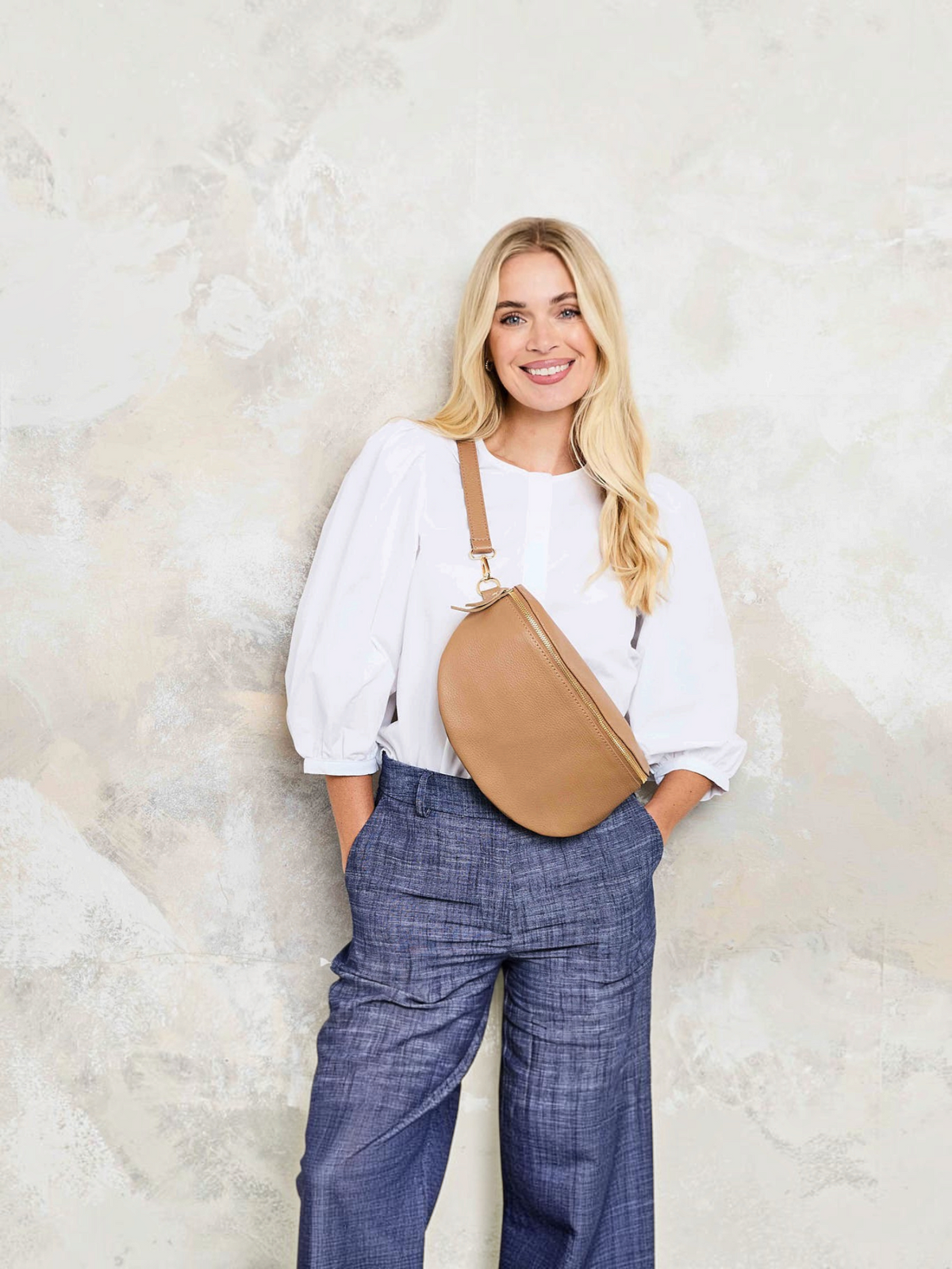 Model Image of a Camel Brown Leather Large Sized Slingbag with matching strap for Women by Elie Beaumont