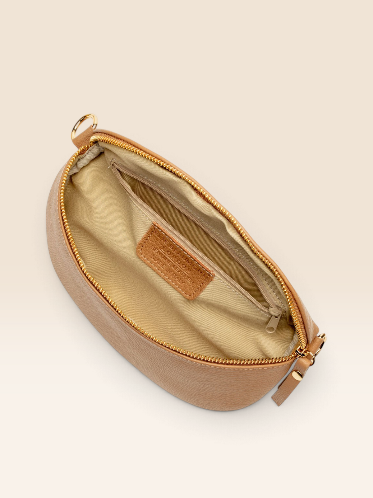 Birds Eye Image of an open Camel Brown Leather Regular Sized Slingbag with matching strap for Women by Elie Beaumont