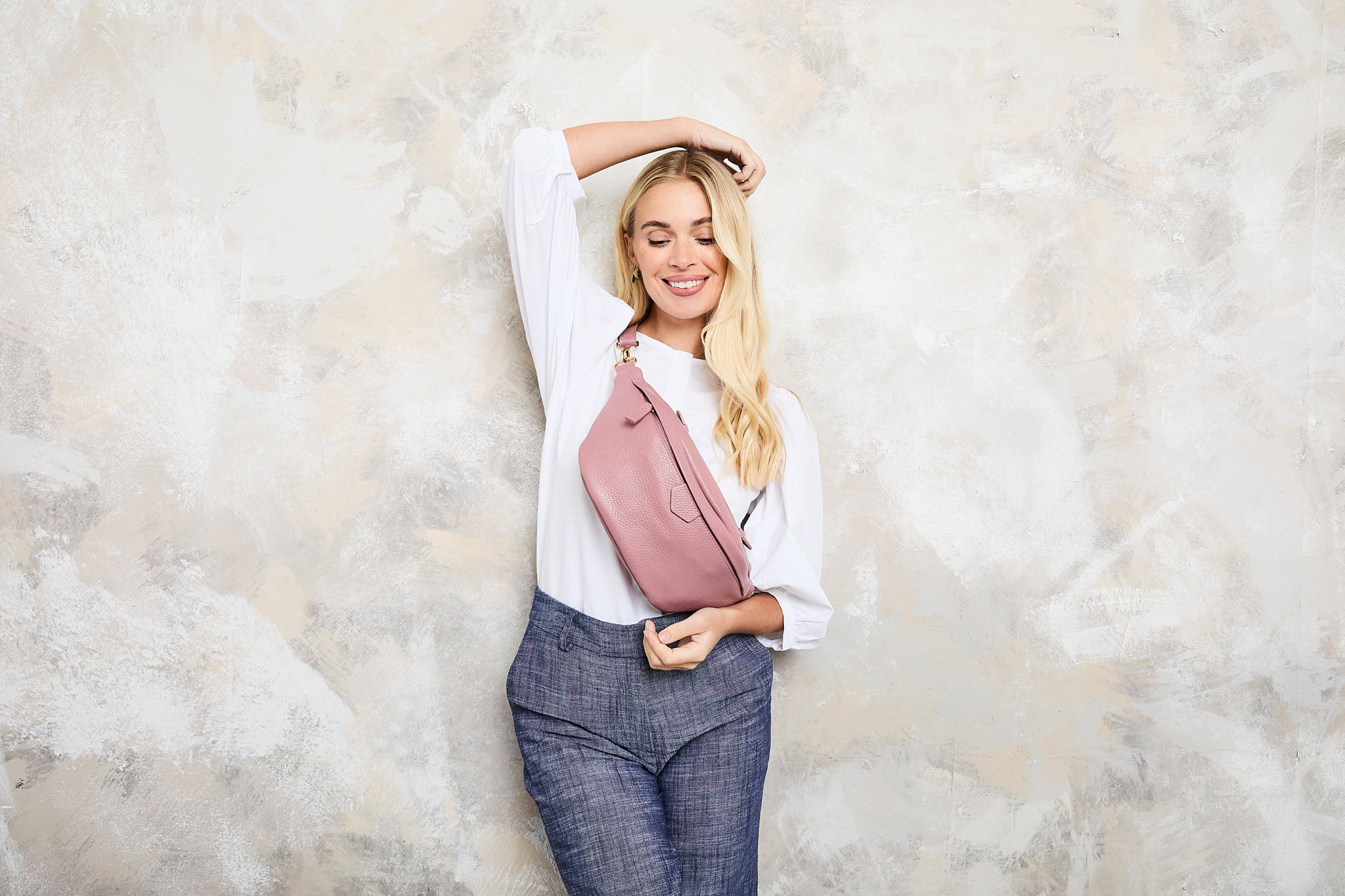 Model Image of a Dusty Rose Leather Arc sling bag with matching strap for Women by Elie Beaumont