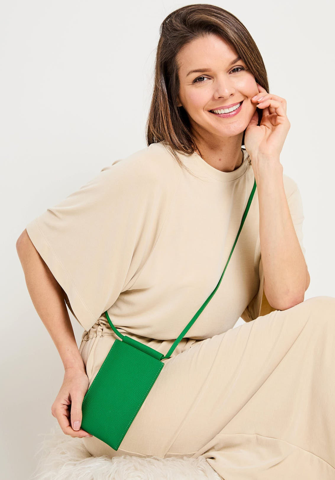 Image of a Model displaying the Jade Leather Phone Pouch for Women by Elie Beaumont
