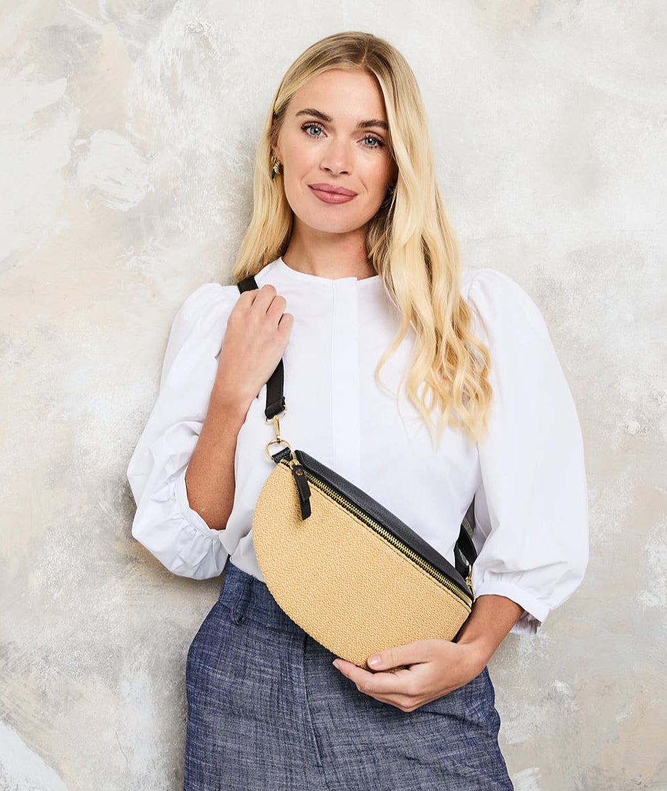 Model Image of a Raffia Black Leather Slingbag with matching strap for Women by Elie Beaumont